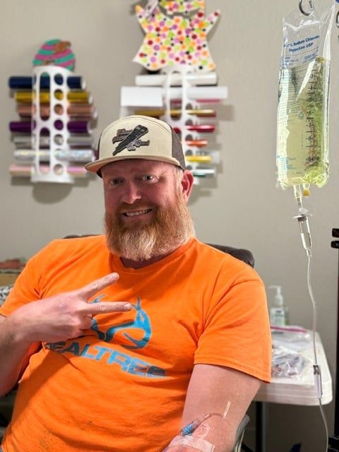 Client smiling during a mobile IV hydration session at home