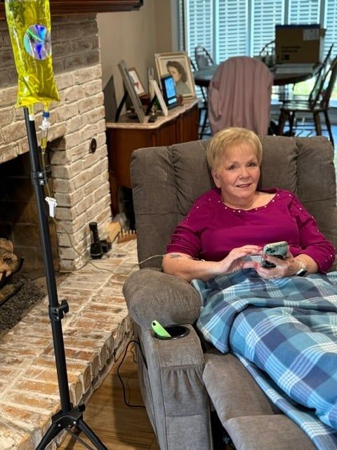 Client relaxing in a recliner during a mobile IV treatment